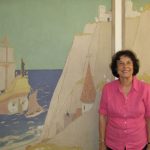 Victoria in front on one of True's seaside murals at Steele Elementary School in Denver.